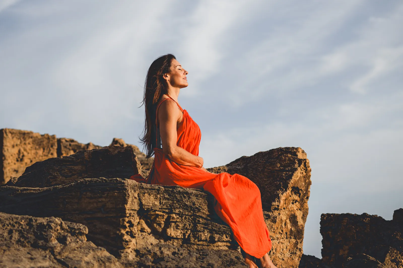 Woman at sunset by the sea
